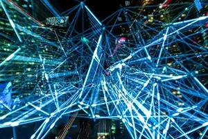 Abstract blue glowing lines form a complex digital network over a blurred city skyline.